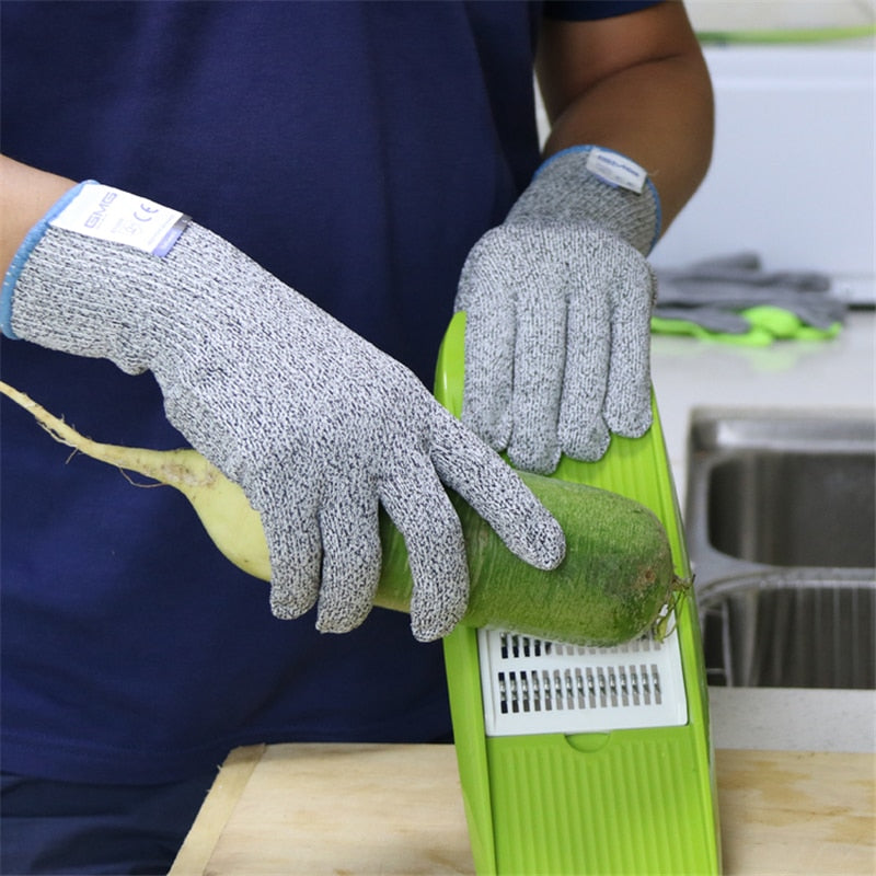 A men slicing veggies with wearing cut resistance gloves